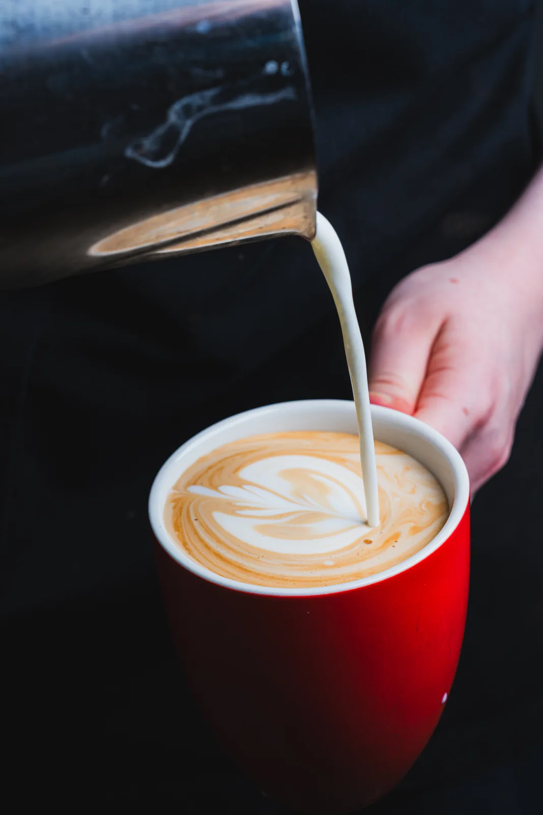 A latte being poured at Superbike Café Racers