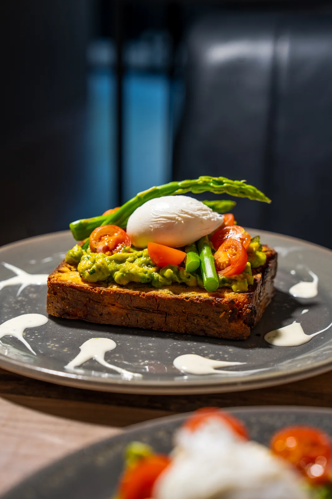 Pumpkin bread topped with avocado and poached egg